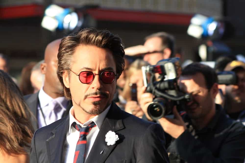 Tony Stark surrounded by reporters