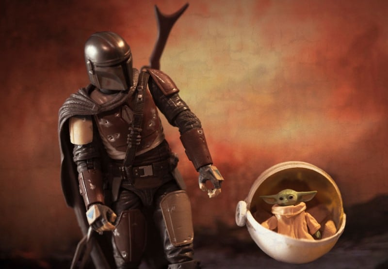 Din Djarin together with Baby Yoda in The Mandalorian series