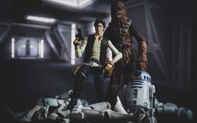 Han Solo with Chewbacca and R2D2 standing on defeated Stormtroopers