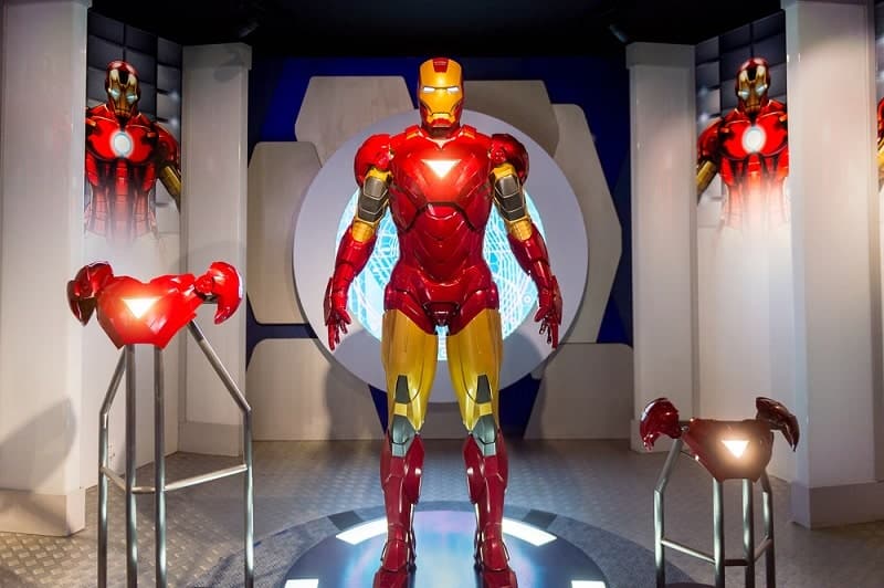 Iron Man standing in a suit gear room
