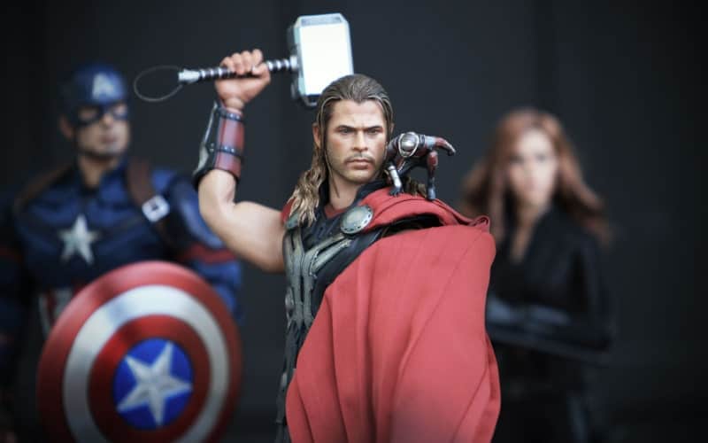 Thor in his fighting pose with Captain America and Black Widow behind