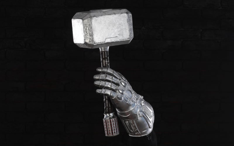 Thanos hand holding Thor's hammer Mjolnir