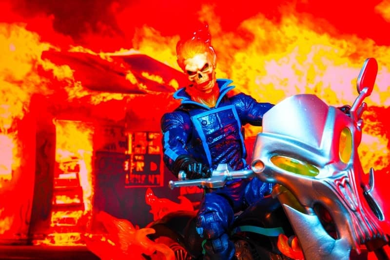 Ghost Rider riding his motorcycle out of a fire