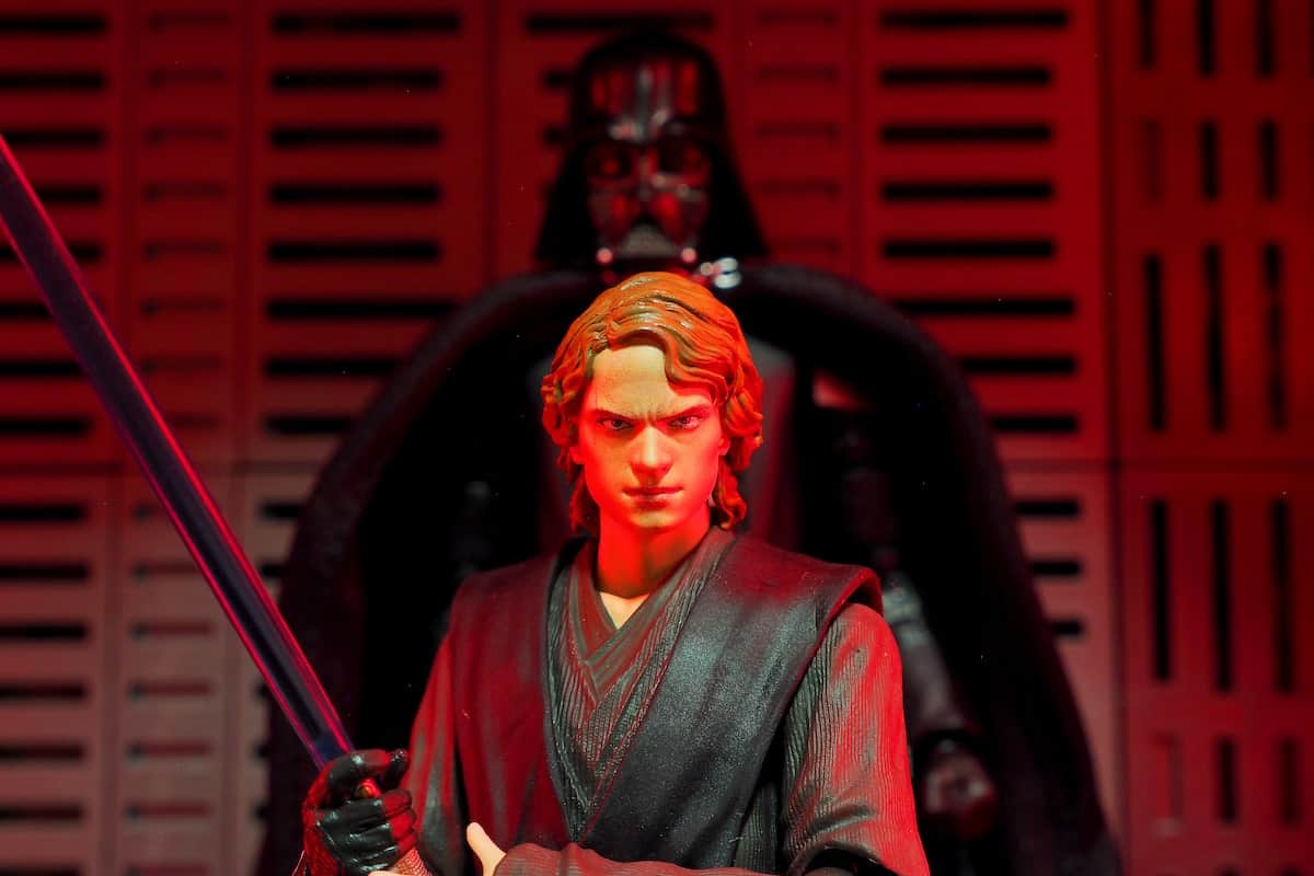 Anakin and Darth Vader behind