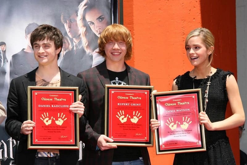 Daniel Radcliffe with Rupert Grint and Emma Watson at the Hand, Foot and Wand Print Ceremony Honoring The Cast of Harry Potter at Grauman's Chinese Theater