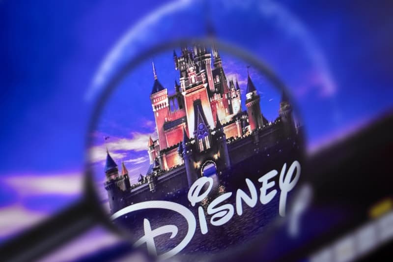 The home page of the Disney site, view through a magnifying glass. Disney company logo is visible
