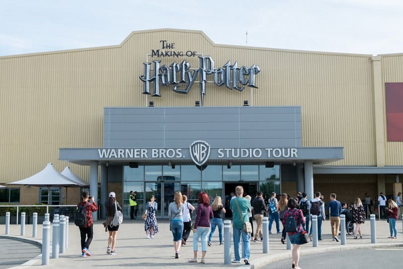 Tourists taking picture in front of the Warner Brothers Studio tour, The making of Harry Potter at Leavesden Studio in London