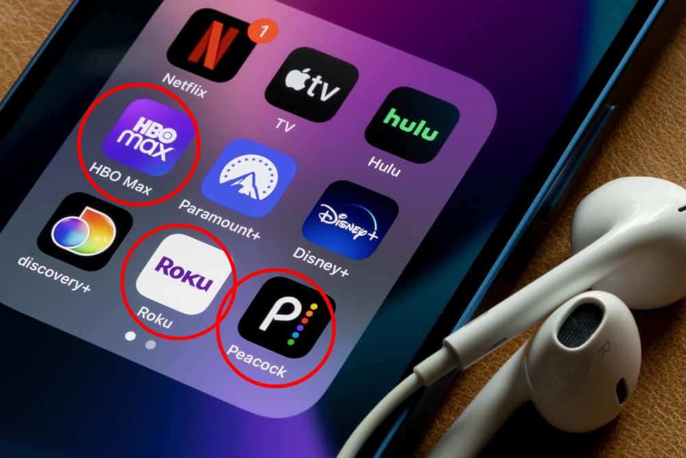 HBO Max, Roku and Peacock apps on a phone